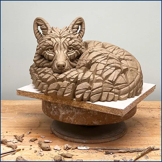 Picture of a Curled up Fox sculpture in clay