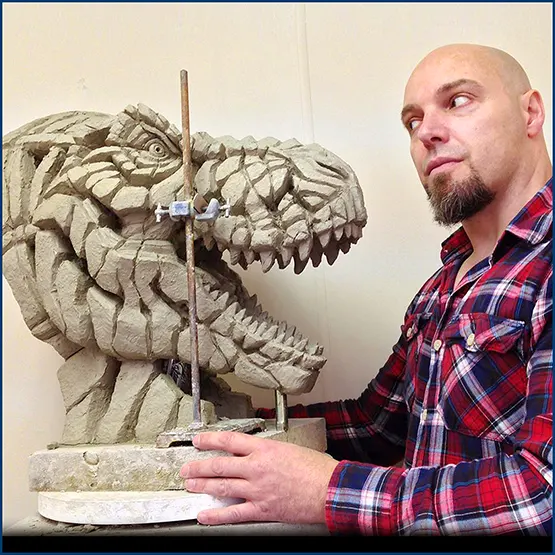 Matt Buckley with a Tyrannosaurus Rex sculpture in clay