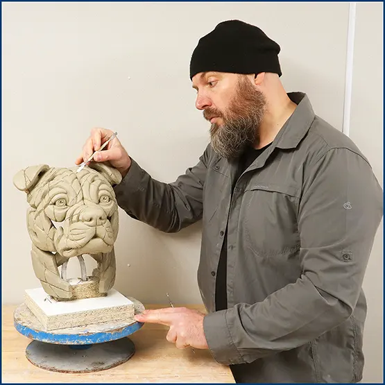 Matt Buckley working on a Staffordshire Bull Terrier sculpture in clay