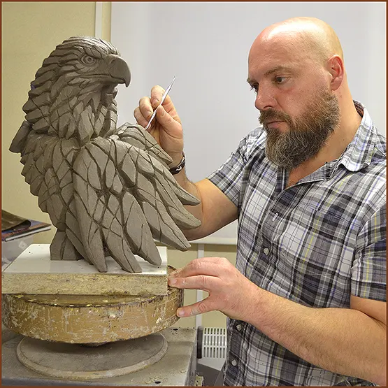 Matt Buckley sculpting a Golden or Bald Eagle sculpture in clay